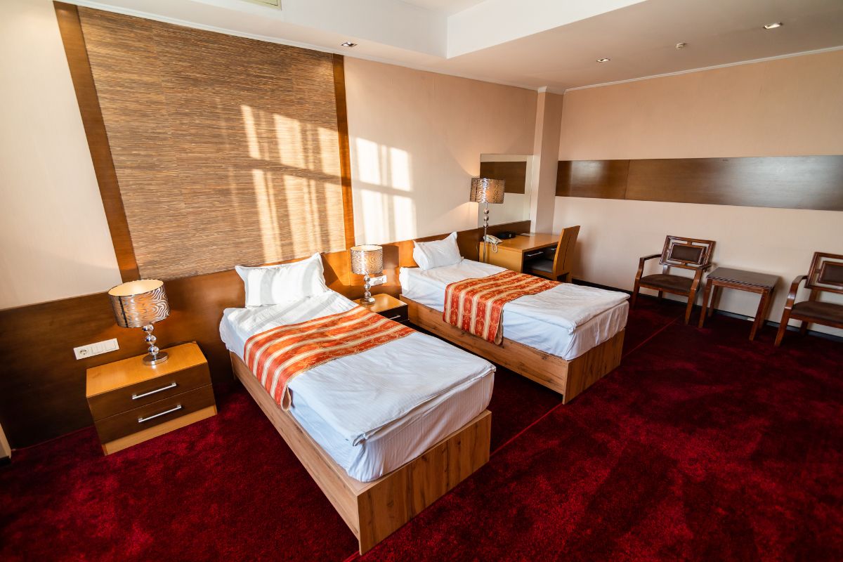 How Much Does a Twin Mattress Weigh? Two twin beds in a room illustrating manageable size and weight compared to larger mattresses