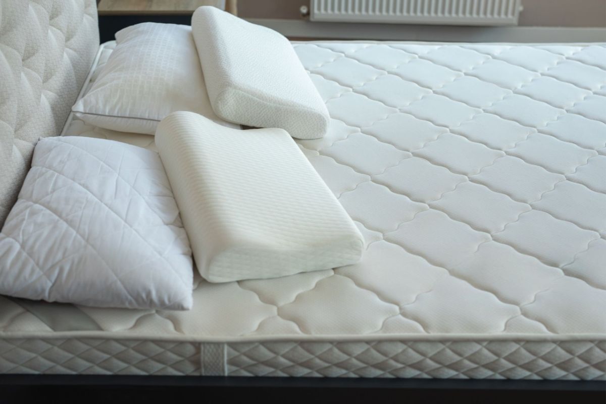Close-up of mattress with pillows showing thickness and materials that affect twin XL weight