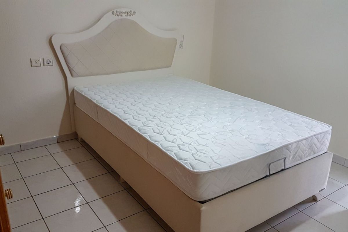 Twin XL mattress on a bed frame showing typical size and structure for weight reference