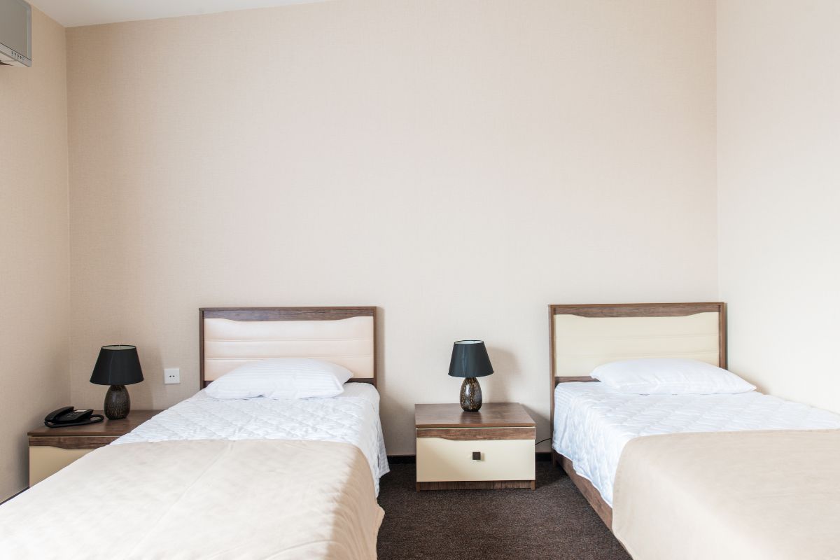 Two twin beds in a room illustrating standard twin bed width and compact sleeping space