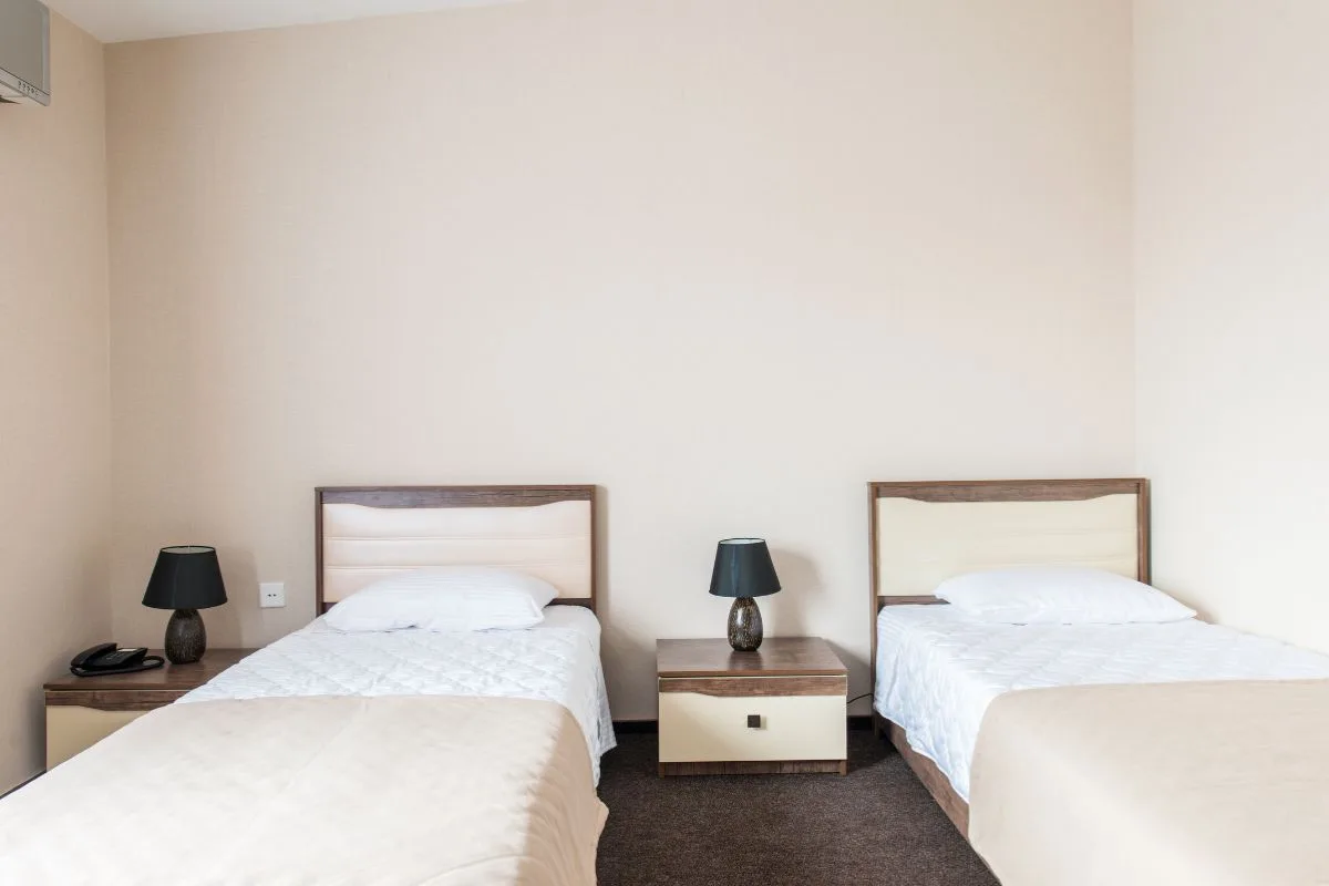 Two twin beds in a room illustrating standard twin bed width and compact sleeping space