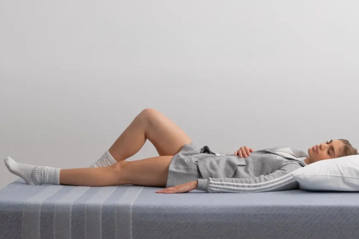Person lying on Leesa Studio mattress demonstrating comfort during the trial period before deciding on a return