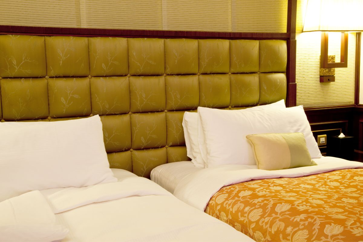 Two Twin Beds Together Make What Size Bed? Two twin beds placed side by side in a hotel room showing how they can form a larger bed