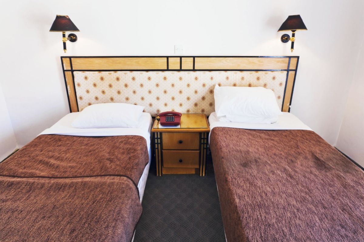 What is the Difference Between a Twin Mattress and a Twin XL? Two twin beds side by side illustrating standard twin mattress size compared in shared spaces