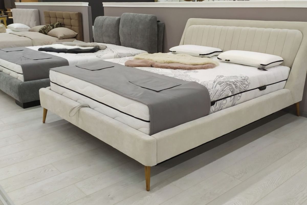 Queen size mattress display in showroom highlighting larger width and extra sleeping space