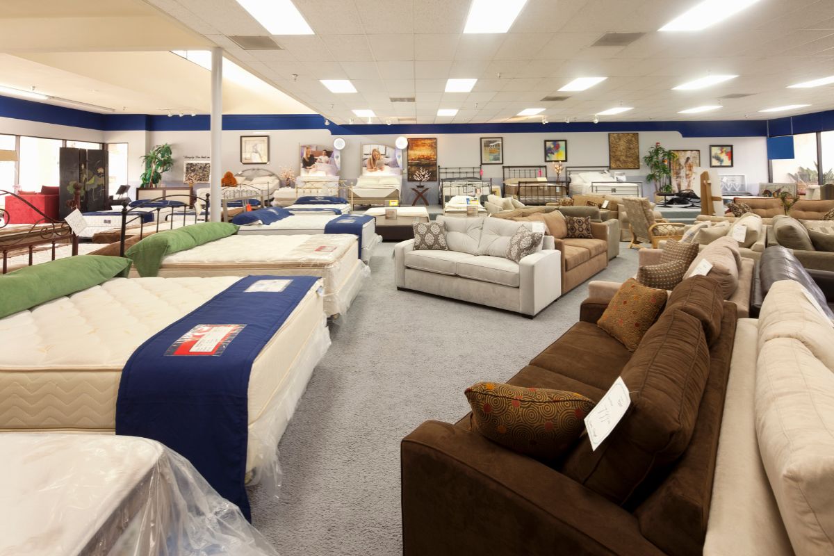 Mattress store showroom with multiple twin mattresses highlighting in-store shopping options