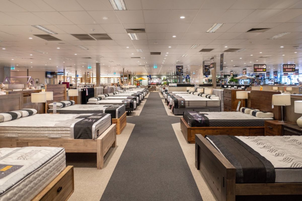 Large mattress showroom with rows of beds highlighting in-store shopping options for Twin XL mattresses