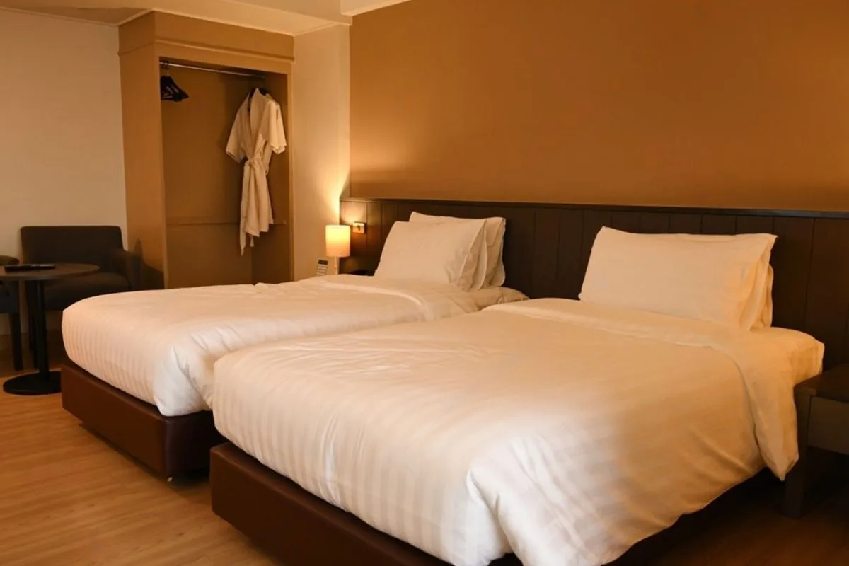 Two twin beds side by side illustrating smaller size compared to a full mattress