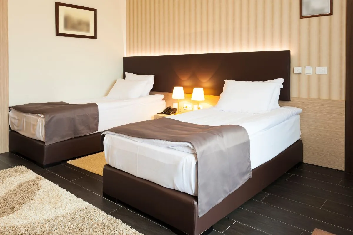 Twin beds in a bedroom setup highlighting narrower width than a full mattress