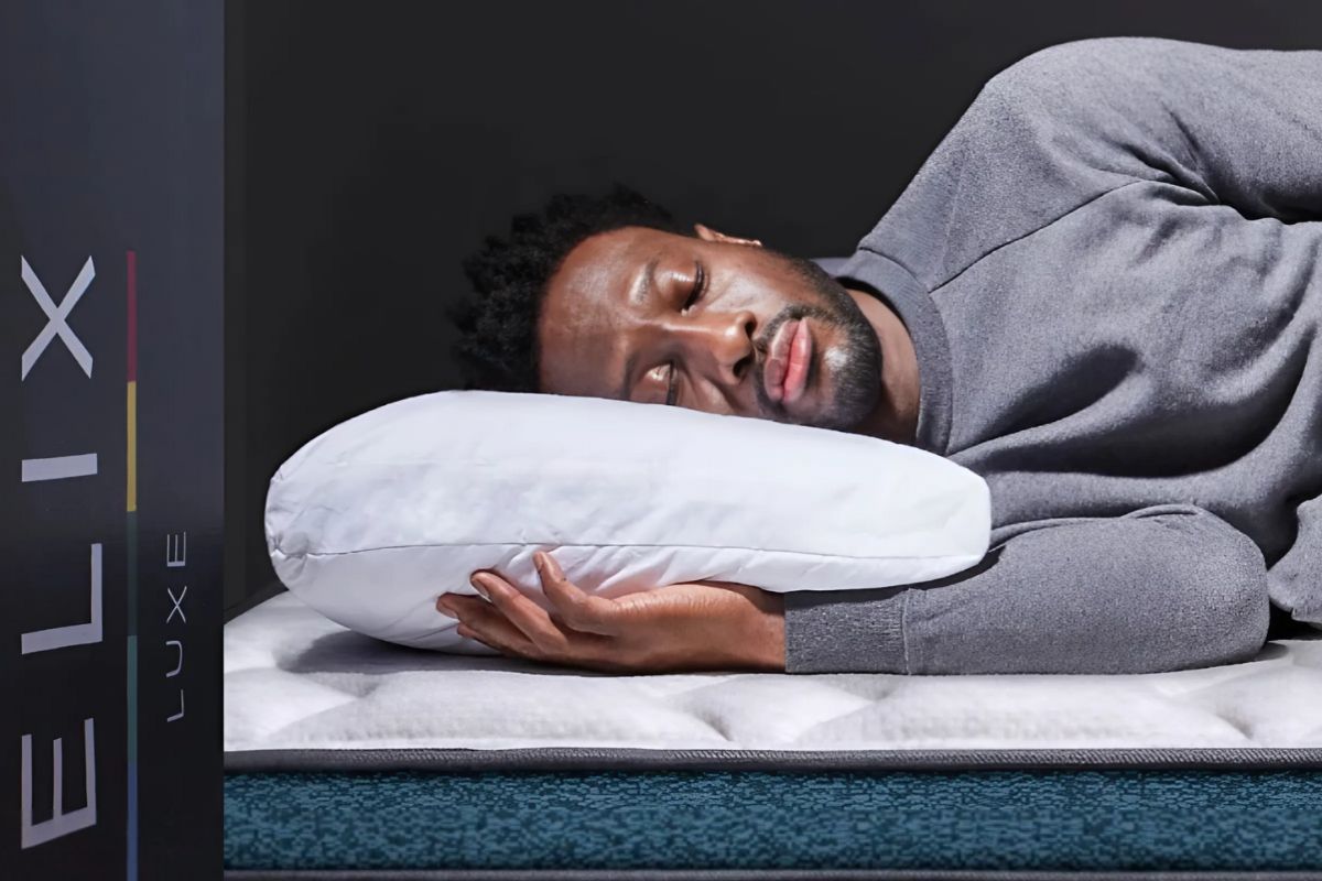 Sleeper testing the comfort of a Helix Sunset Luxe mattress before deciding whether to keep or return it