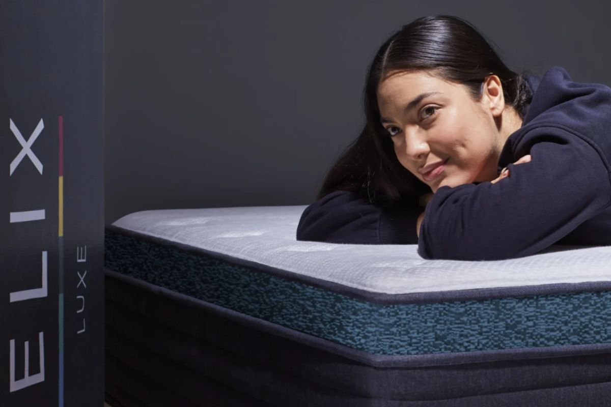 Woman relaxing on a Helix Sunset Luxe mattress during the home sleep trial period to test comfort and softness