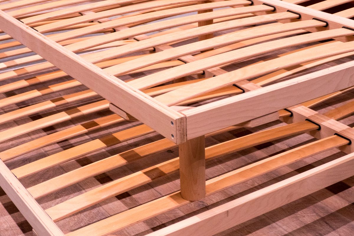 How to Firm Up a Memory Foam Mattress? Wooden slatted bed frame providing stronger support under a memory foam mattress