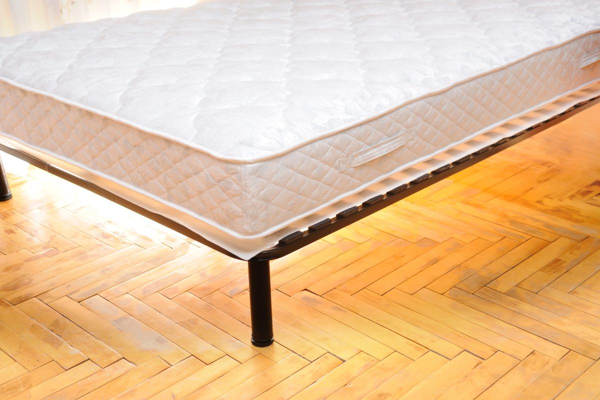 How to Store a Twin Mattress? Twin mattress placed on a raised frame to prevent moisture damage during storage