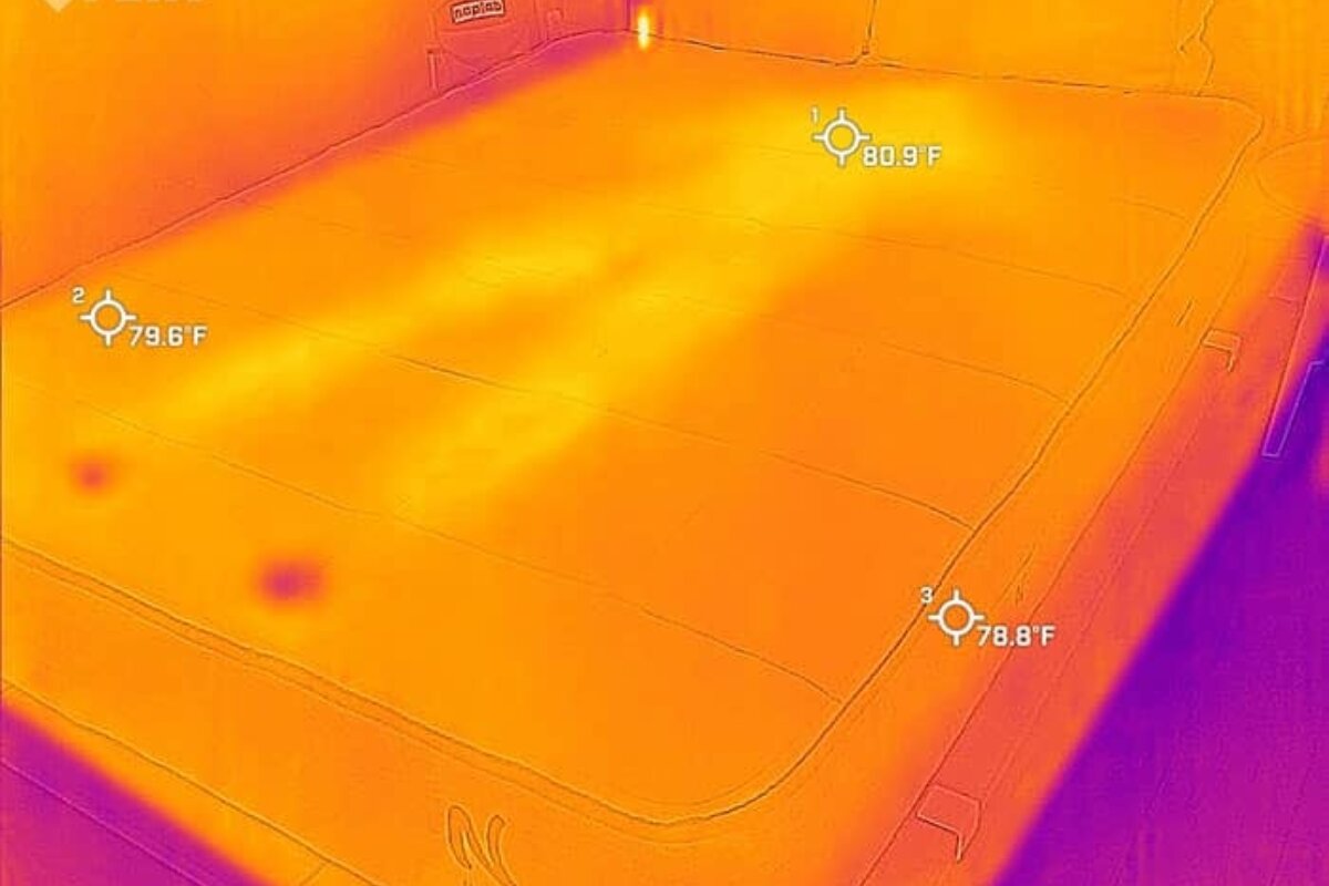 A heat image of a person after they laid down on the bed, barely visible.