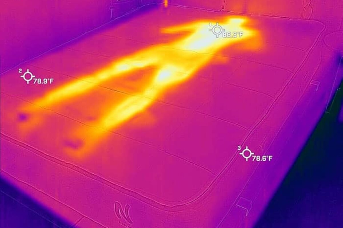 A heat image of a person after they laid down on the bed, very visible.