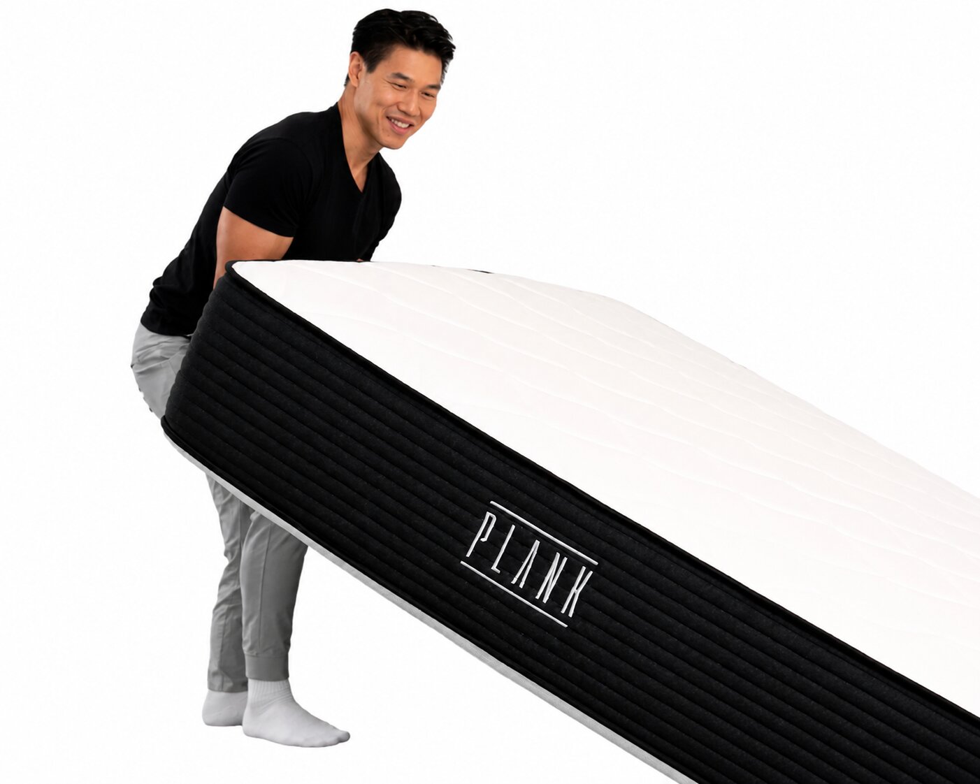 person lifting and carrying a plank mattress to demonstrate its weight and maneuverability