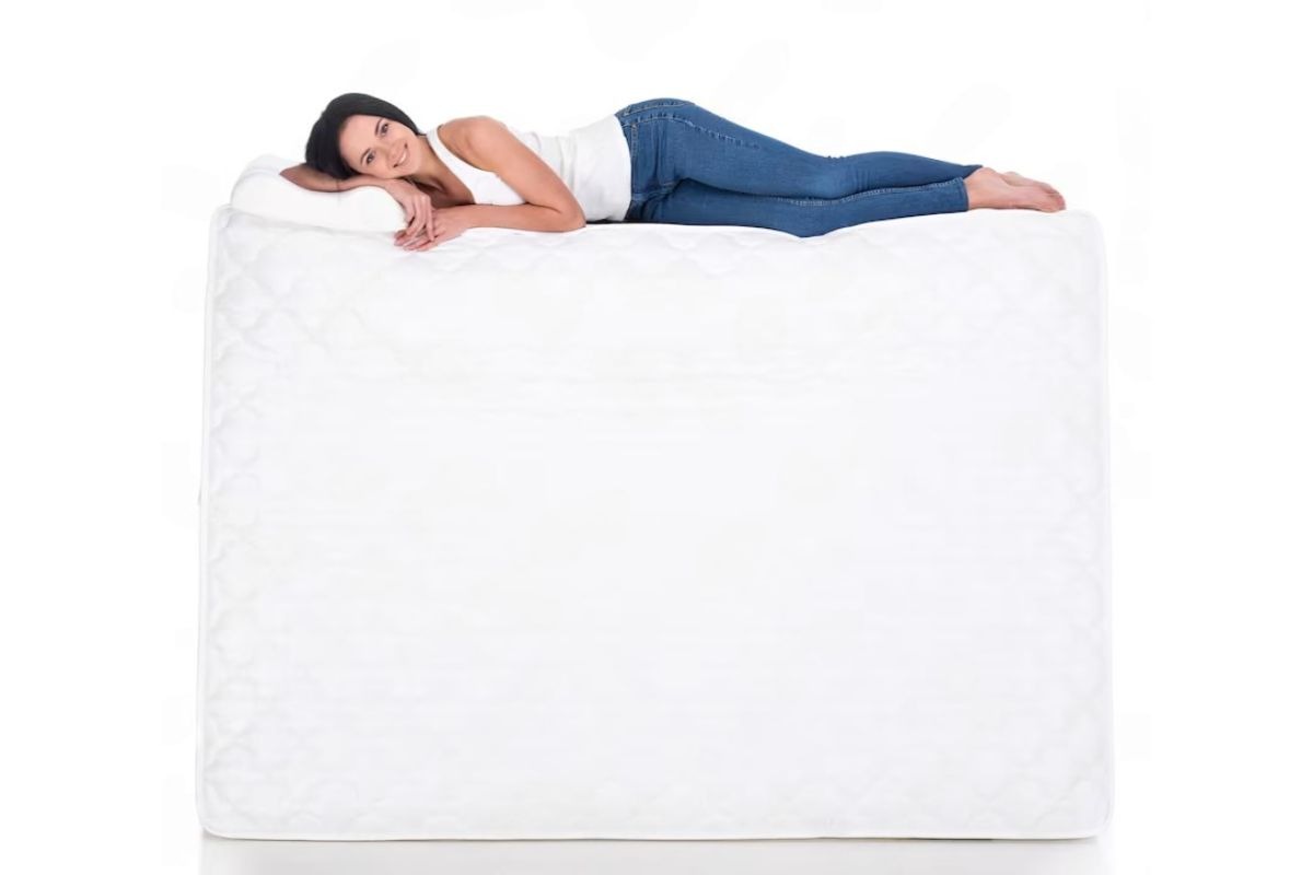 Plush or Medium Mattress: Key Differences Explained Woman lying comfortably on a medium-feel mattress to demonstrate balanced support and pressure relief