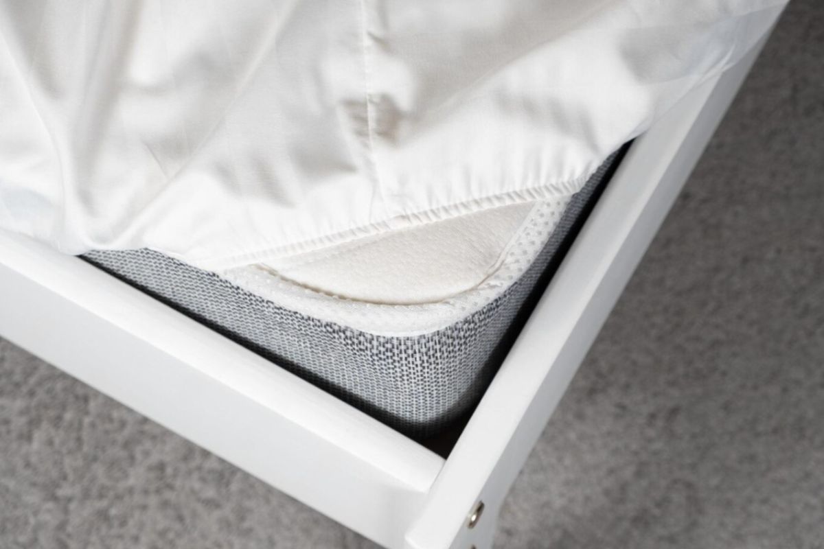 Plush or Medium Mattress: Key Differences Explained Close-up of a mattress with a fitted sheet highlighting mattress height and firmness feel differences