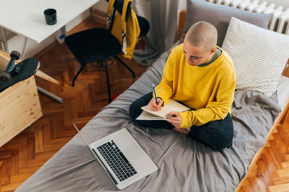 Twin XL Mattress Cost: Exploring Different Price Ranges Person using a Twin XL mattress in a compact space highlighting affordability for students
