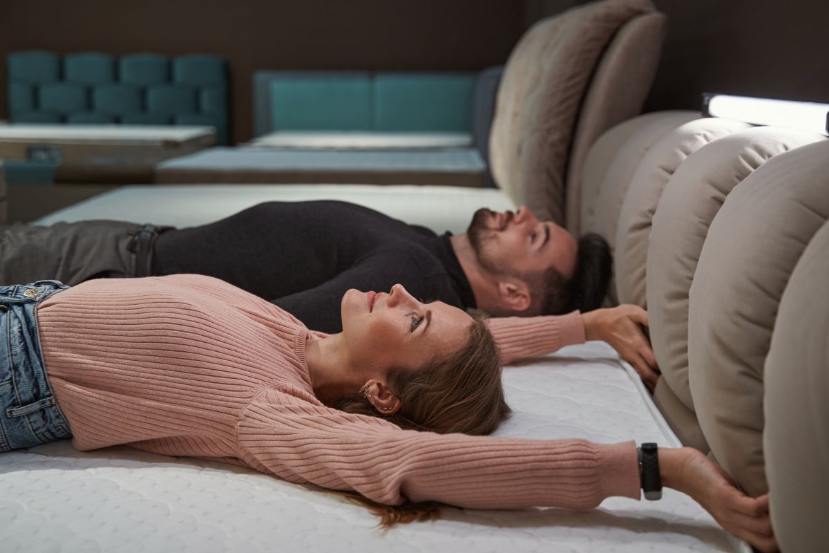 What Does Extra Firm Mattress Mean? Couple lying flat on a firm mattress demonstrating reduced sinkage and solid support feel