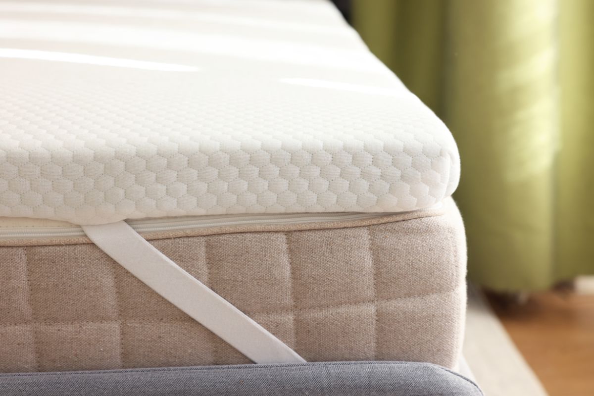 Hands adjusting firm mattress on bed frame demonstrating stability and edge support