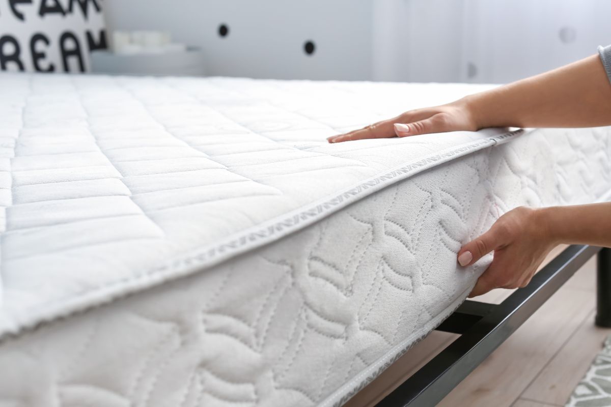 Couple testing mattress firmness in store to compare extra firm mattress support