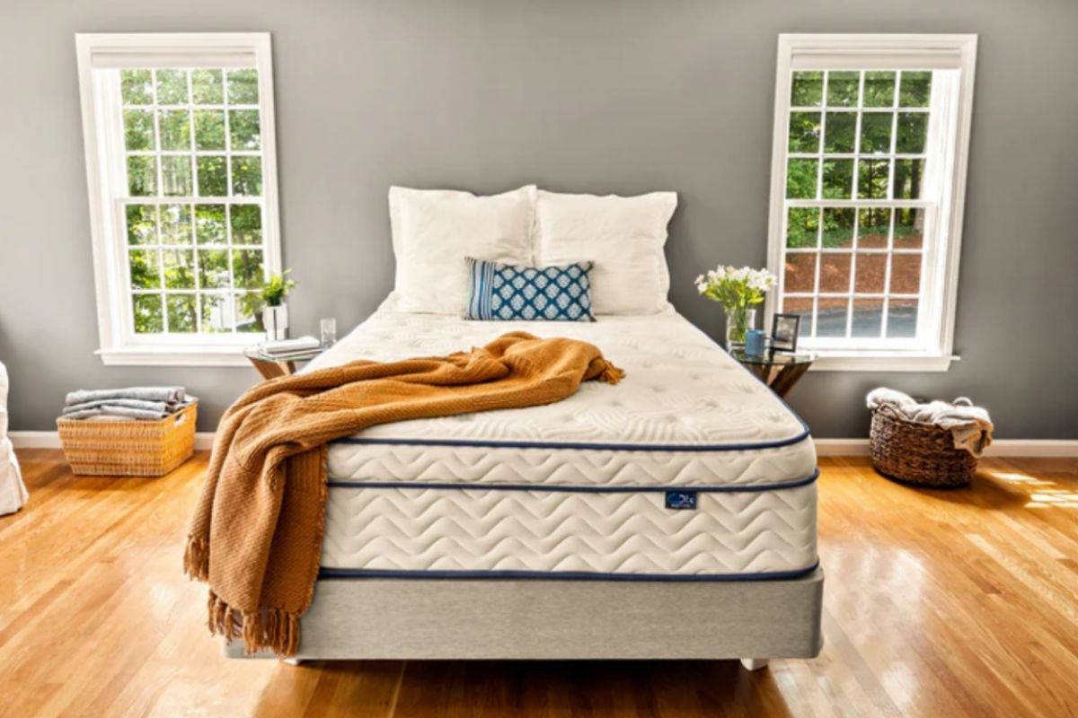 Comfortable mattress in a serene bedroom highlighting the importance of a supportive sleep setup alongside noise therapy