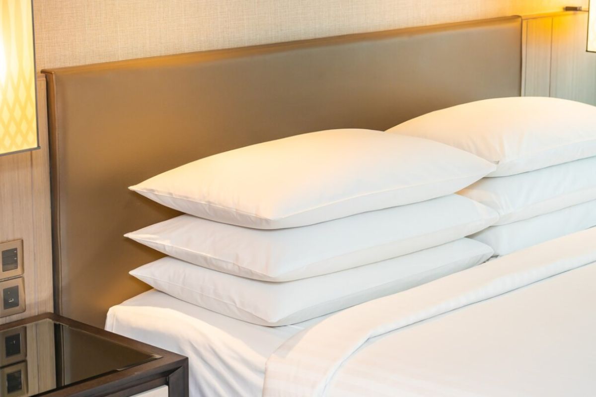 Stack of soft pillows on a neatly made bed illustrating the plush comfort of a medium soft mattress