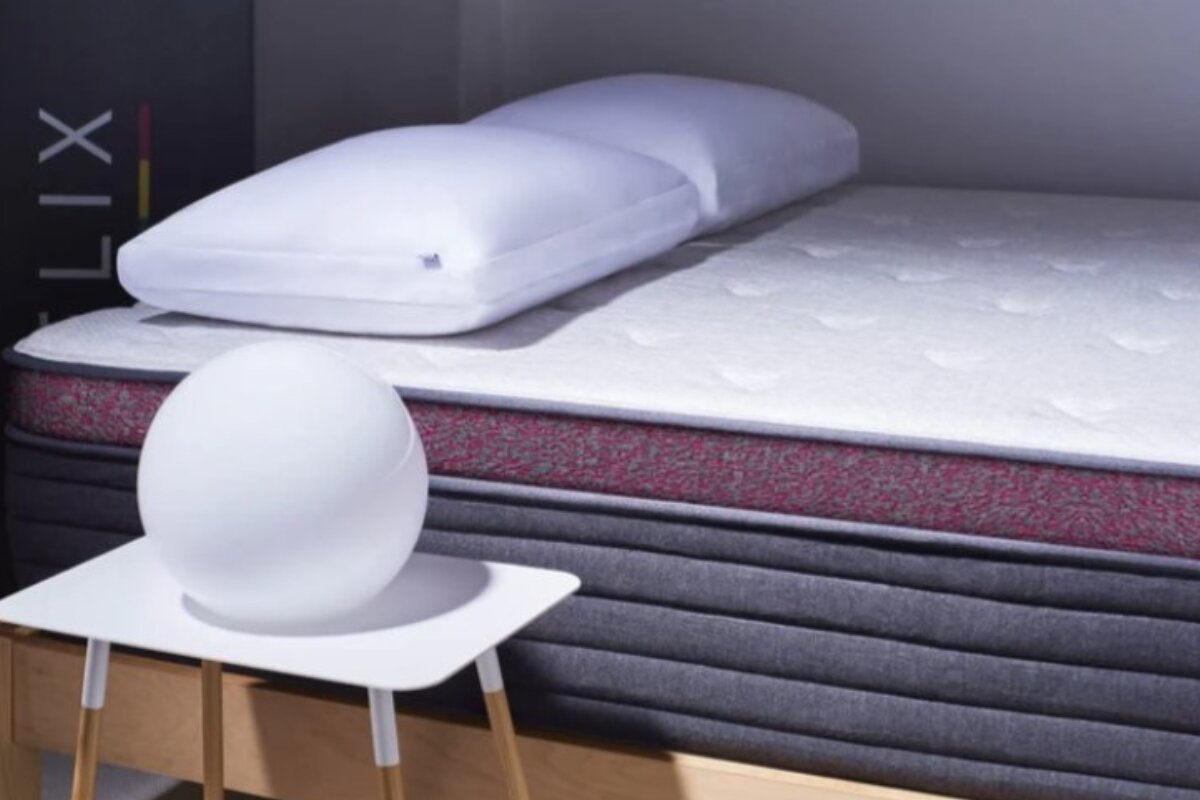 helix dusk luxe mattress with pillow resting on the bed in a modern bedroom setting