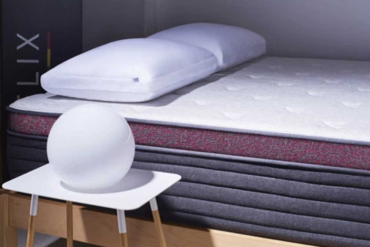 helix dusk luxe mattress with pillow resting on the bed in a modern bedroom setting