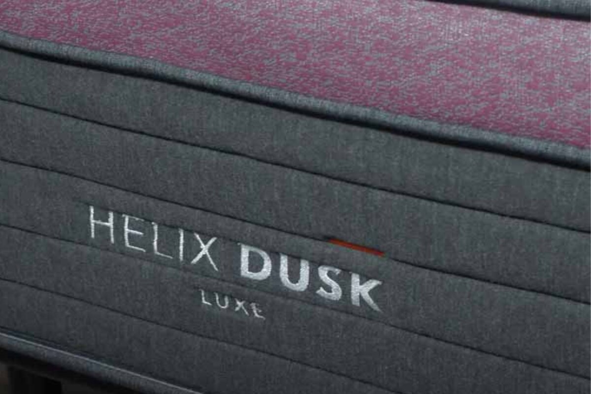 close up view of the helix dusk luxe mattress side panel with branded logo detail
