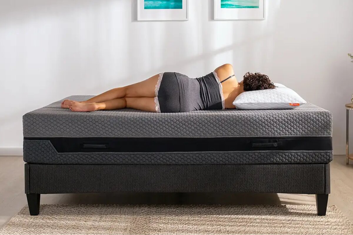 A woman laying down on the Layla Hybrid Mattress.