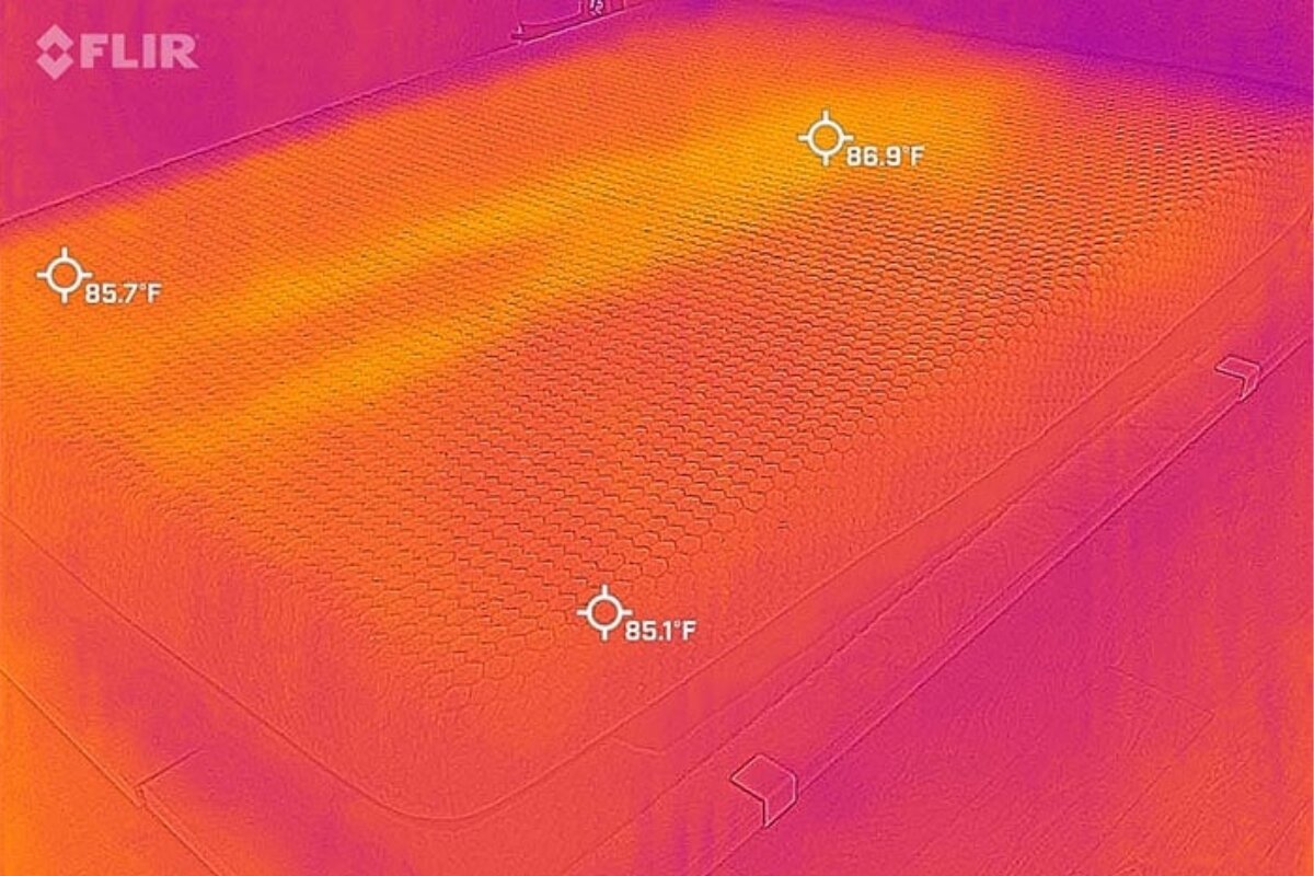 A heat image of a person laying on a bed, very visible.