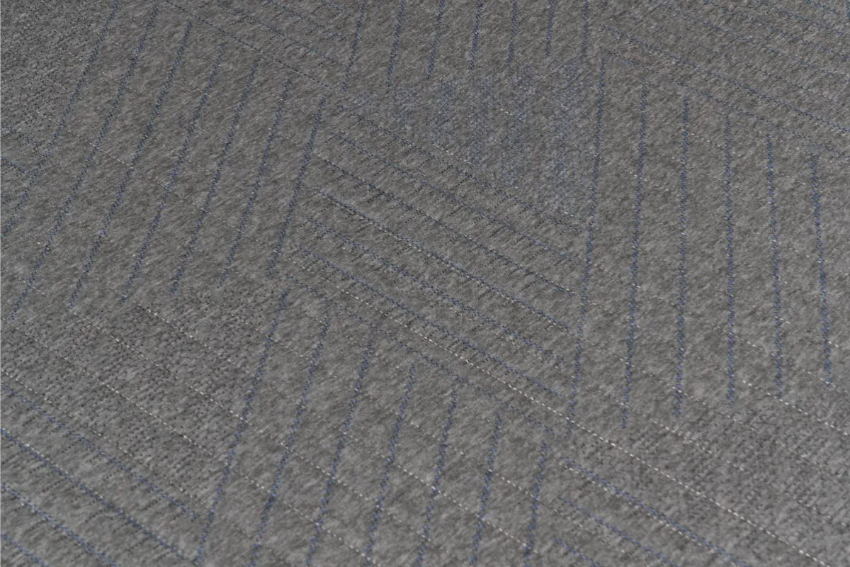 Close-up of the Dreamfoam Essential mattress cover texture showing fabric quality and surface design details discussed by customers
