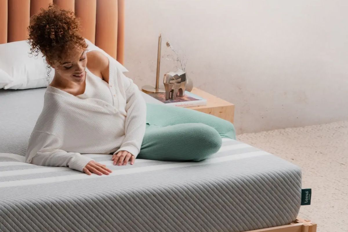 Woman relaxing on a Leesa Original Mattress demonstrating comfort and pressure relief during everyday use