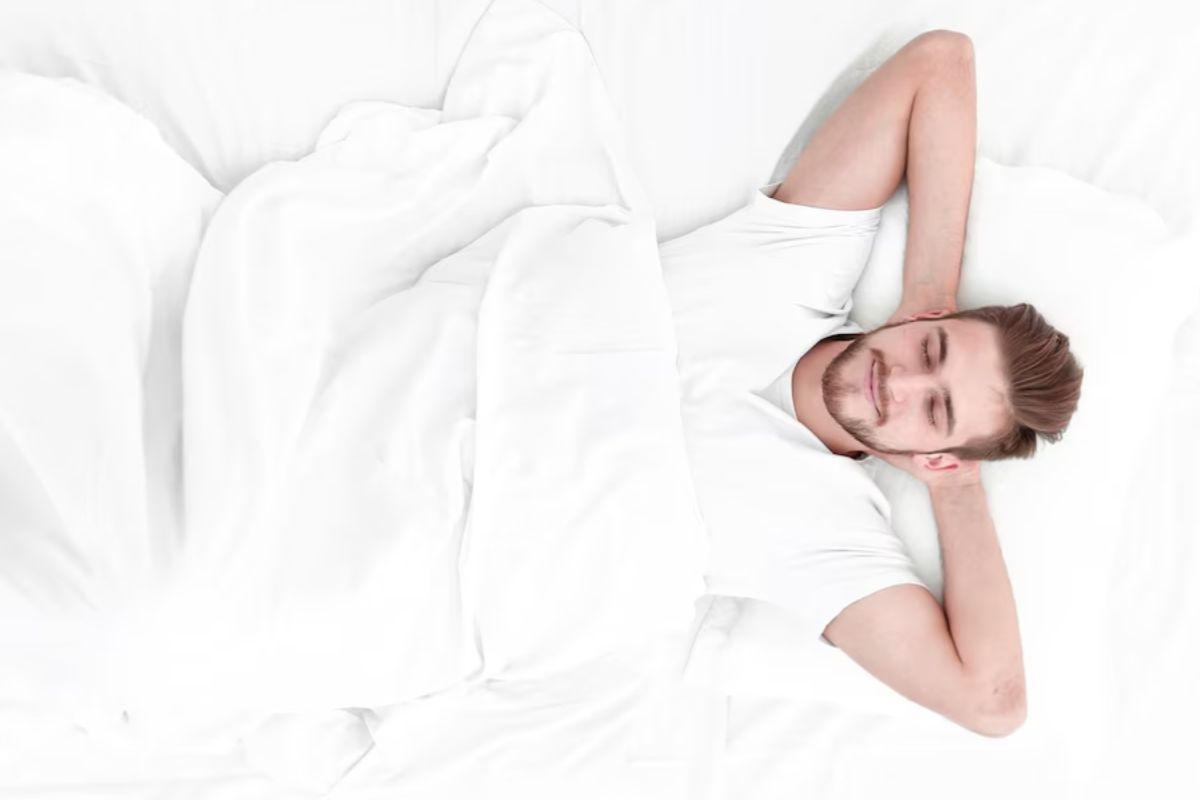 Man sleeping comfortably on a medium firm mattress designed for balanced support and spinal alignment