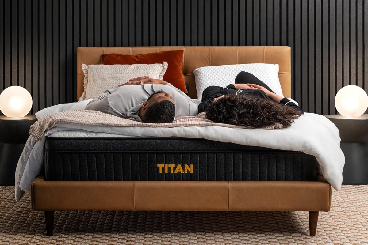A couple lying down on the Titan Plus Luxe mattress.