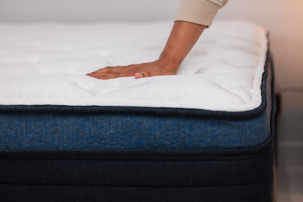 A person pressing on the Helix Midnight Luxe.