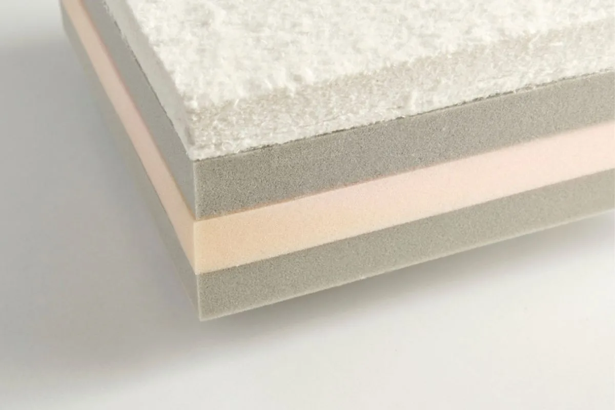 Close-up of layered memory foam materials showing the foam construction that affects mattress pricing