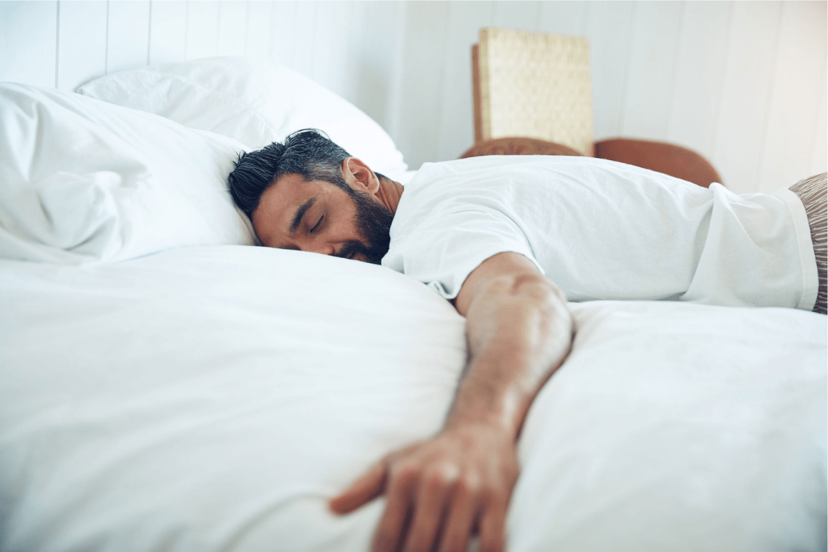 A Man Sleeping Comfortably on his Stomach plush vs firm mattress