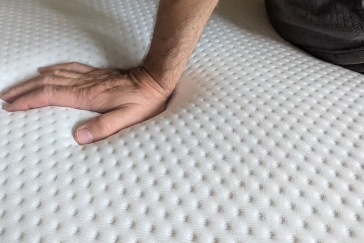 hand pressing into emma elite mattress surface showing responsiveness and quick recovery