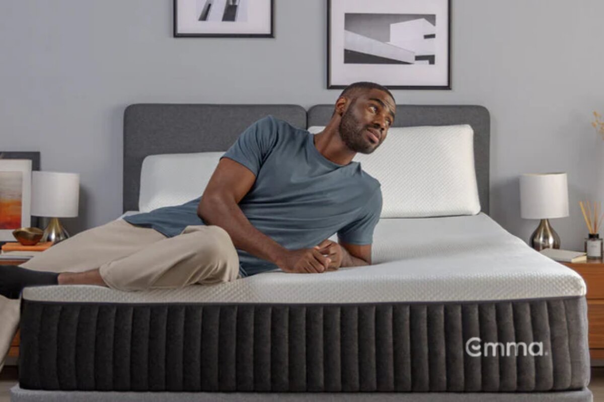 man lying on side on emma elite mattress demonstrating comfort and support for side sleeping