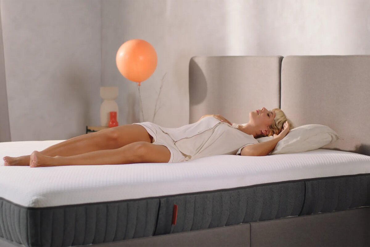 woman lying on back on emma elite mattress showing full body support and comfort