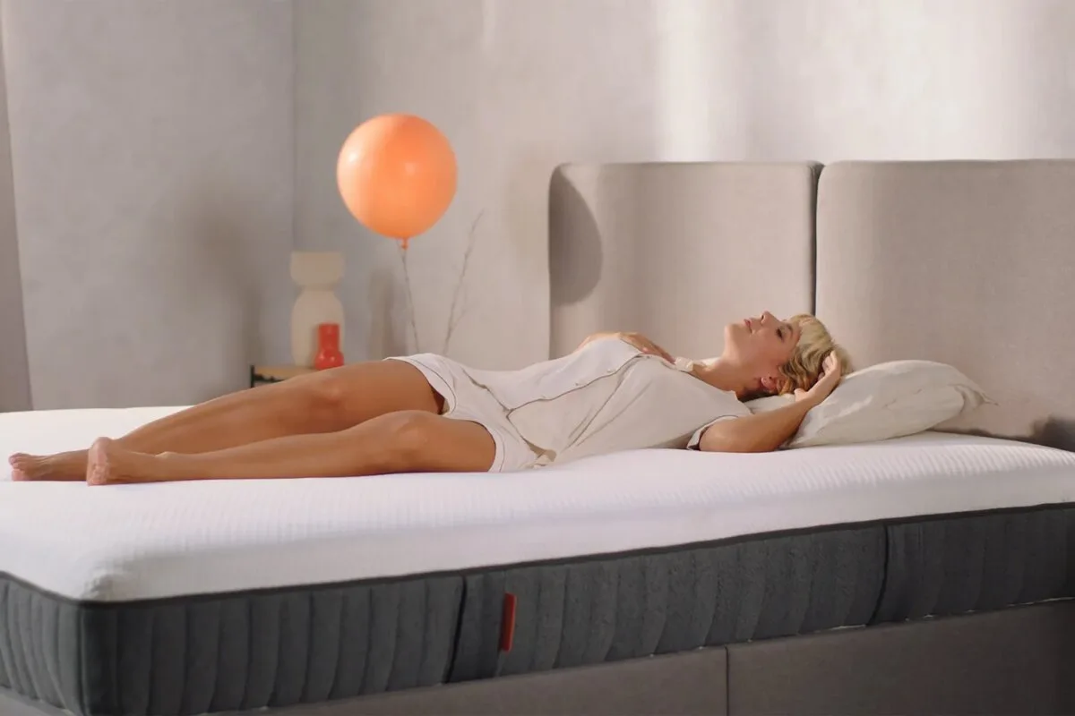 woman lying on back on emma elite mattress showing full body support and comfort