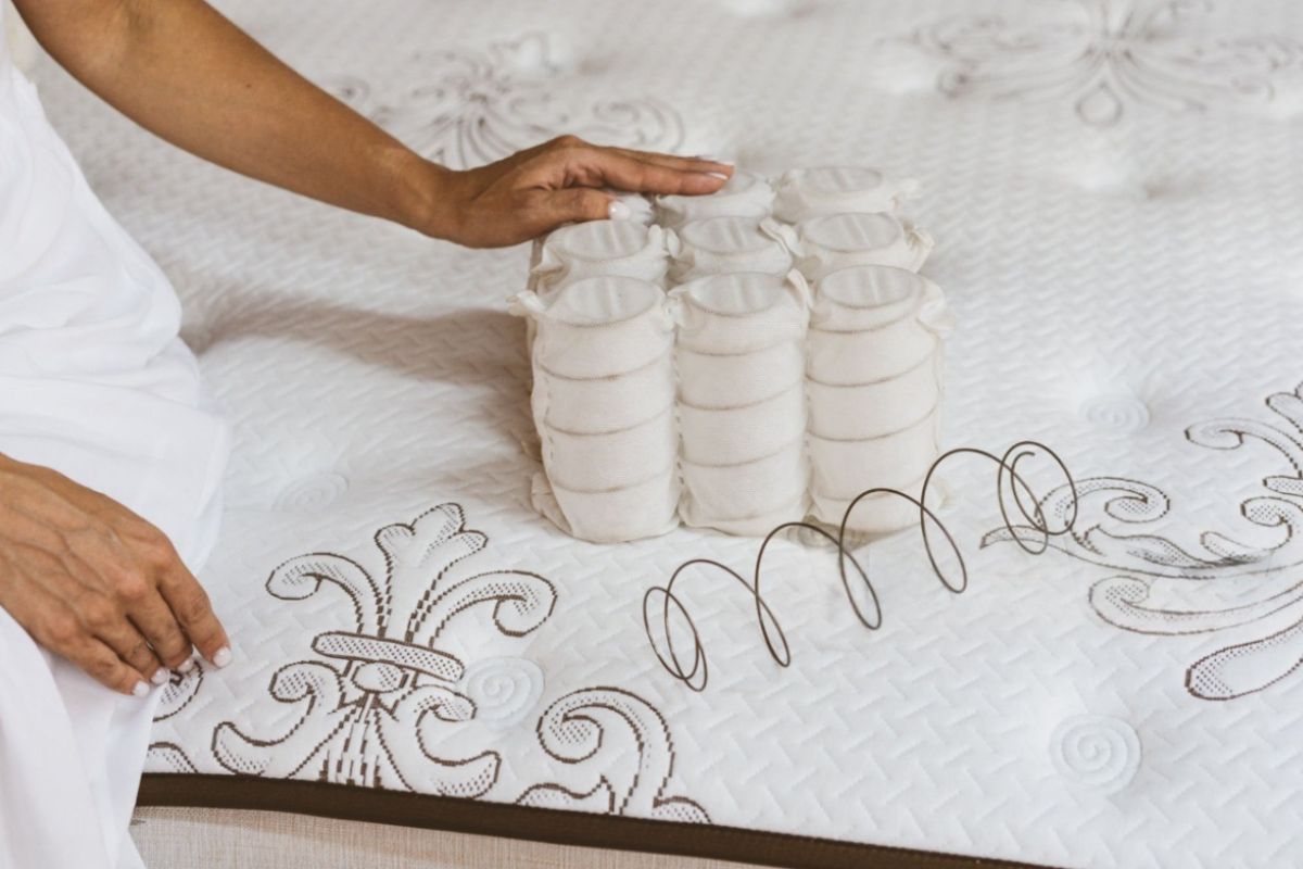 Pocketed coils and traditional innerspring coils displayed on a mattress, illustrating the support components that influence innerspring mattress durability and lifespan.