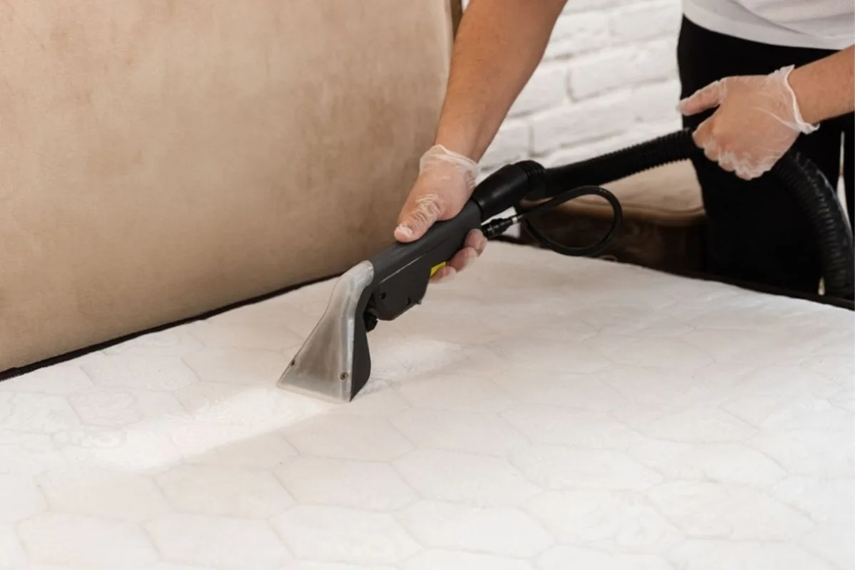 Using a wet-dry extraction tool on a mattress to remove excess water and speed up memory foam mattress drying