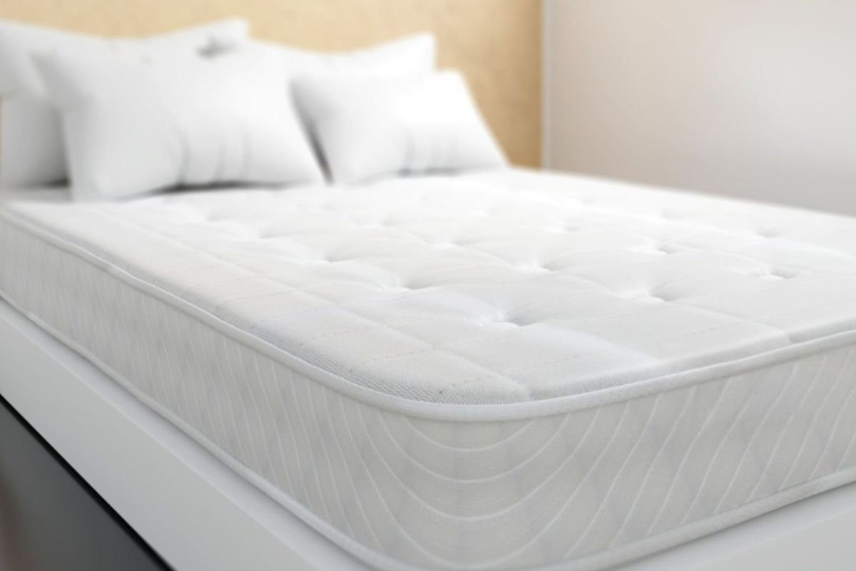 Close-up of an innerspring mattress, highlighting the quilted comfort layer and traditional coil mattress design