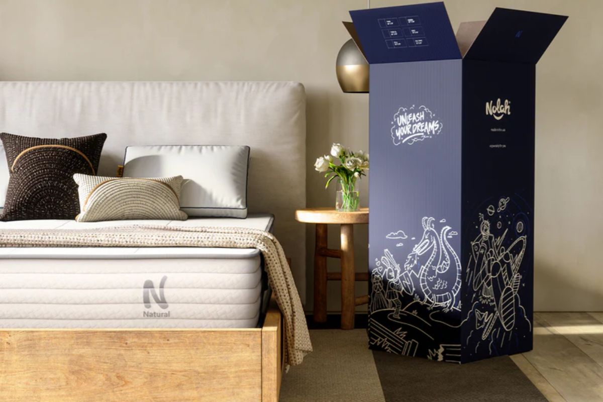 Nolah Natural 11 mattress alongside its shipping box, illustrating the unboxing and setup experience customers can expect during the trial period