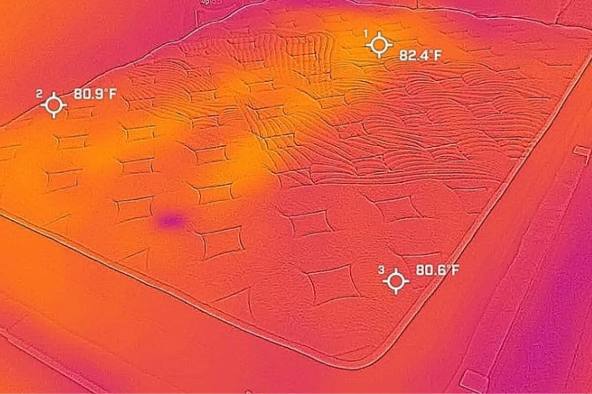 A heat image of a bed after a person has tried it, barely visible.