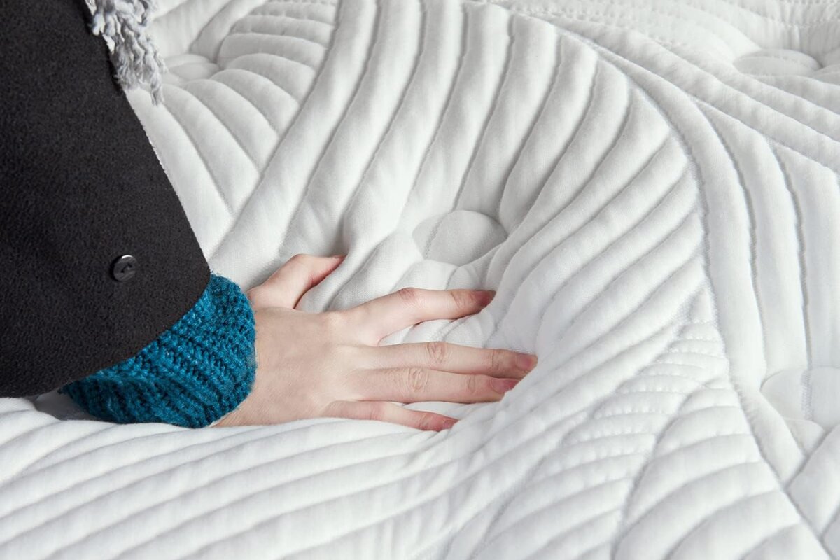 A person pressing on a bed.